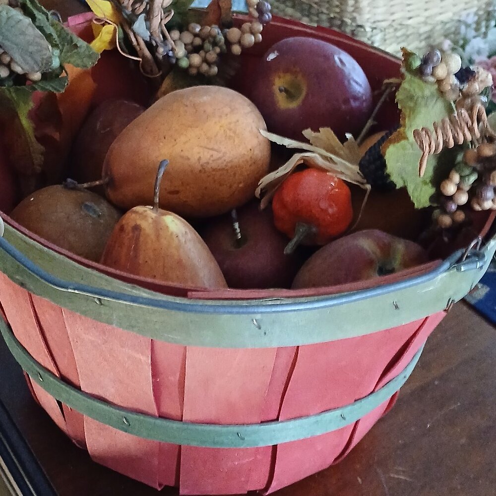 Basket of artificial fruit apples pears corn banana